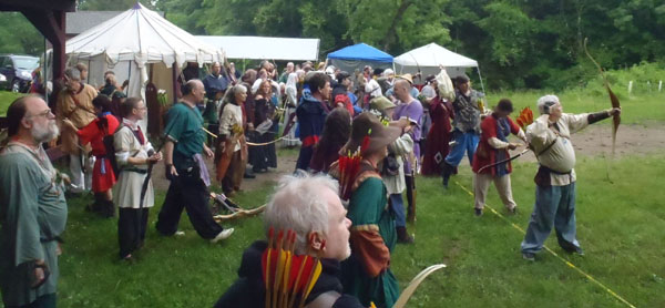 Assembled Royalty, spectators and archers.